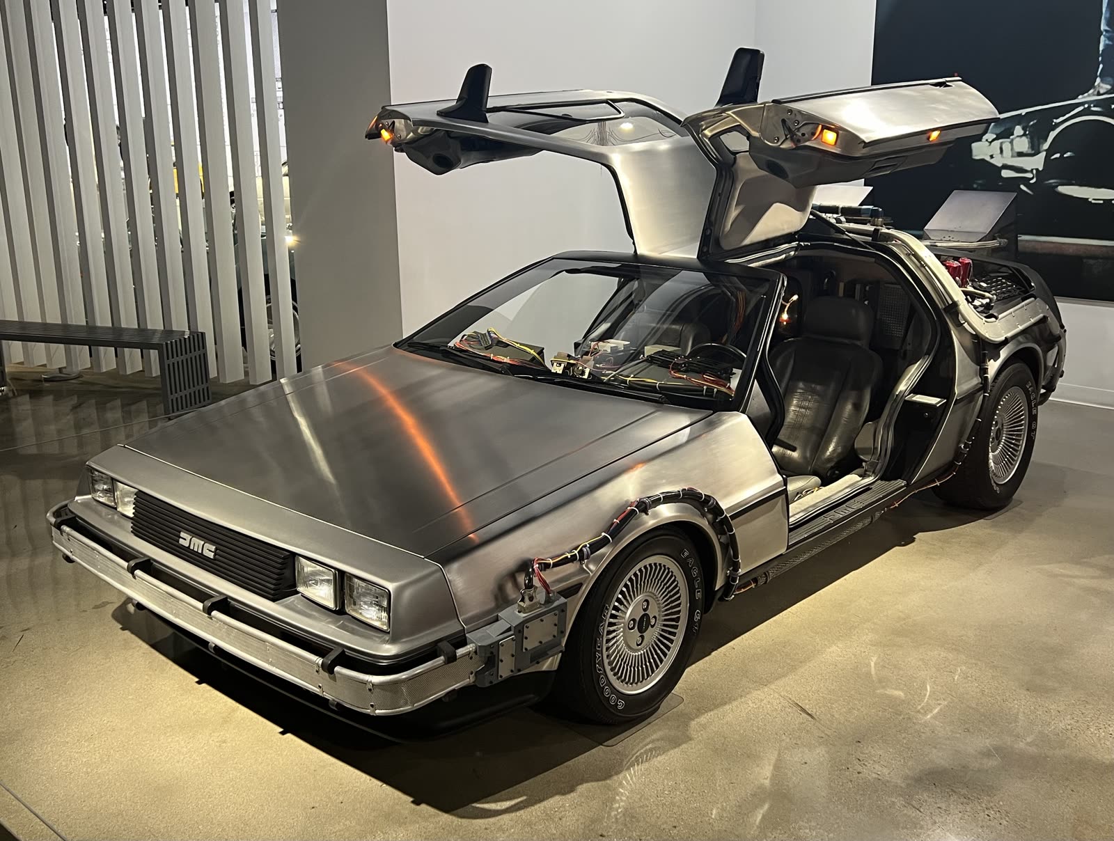 The DeLorean time machine from Back to the Future with its gull-wing doors open, at the Petersen Automotive Museum