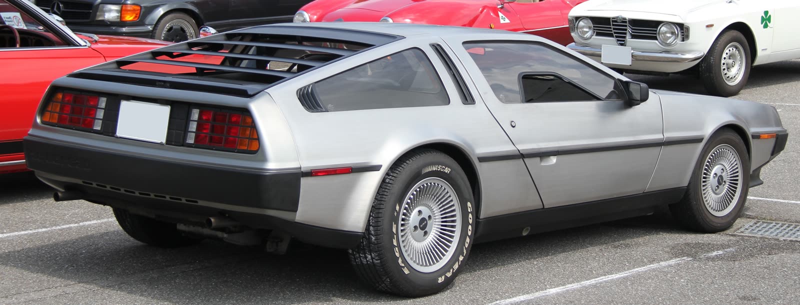 A regular silver DeLorean DMC-12 seen from the rear